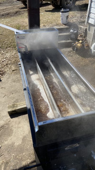 Maple syrup boiling in a divided pan